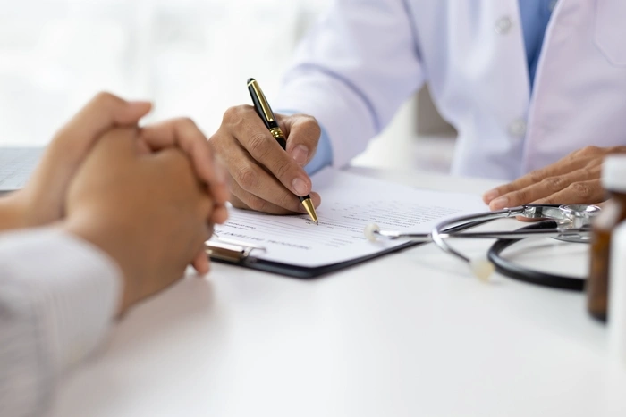 Doctor diagnosing a woman's illness in a hospital examination room