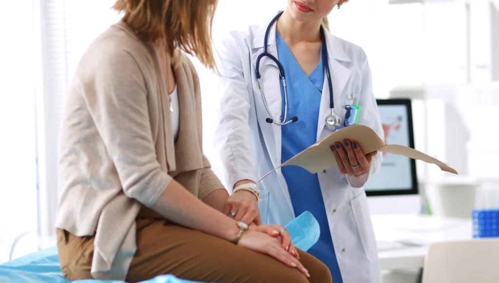 Doctor and patient discussing something while sitting at the table