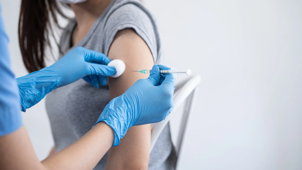 Hand of young woman nurse, doctor giving syringe vaccine