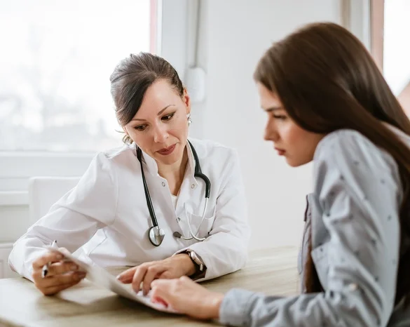 Charming female doctor giving advice to a female patient.