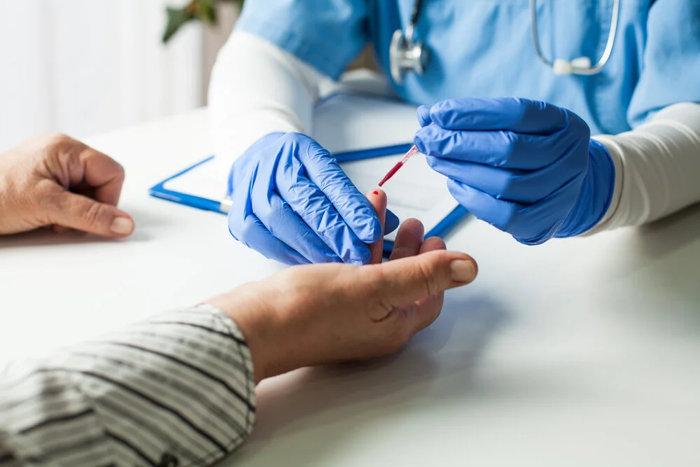 doctor taking patient blood sample